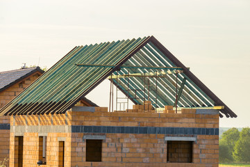 Obraz premium Construction of a house made of bricks, roof repair, new building
