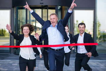 Business people crossing the finish line