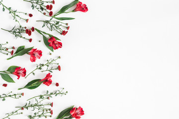 Flowers composition. Frame made of various red flowers on white background. Flat lay, top view,...