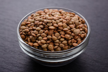 raw lentils on a dark stone background