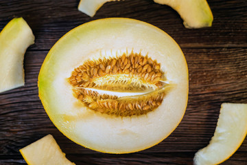 Fresh half of melon on wooden background, top view