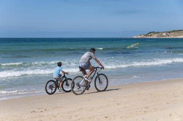 Fototapeta na wymiar Cycling along the beach