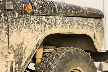 A car in the mud, after a trip off-road, close-up
