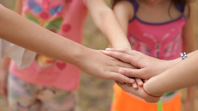 Children have a lot of fun in the summer on the lawn in the park, laugh and play fun.