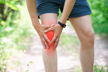Pain in knee, joint inflammation, massage of male leg, injury while running, trauma during workout