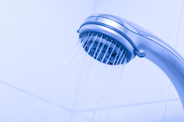 Naklejka na ściany i meble Head shower while running water. Close up