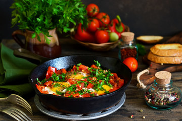 Shakshuka is a traditional breakfast of Israeli cuisine. Eggs fried in tomato sauce with pepper, onions and spices.
