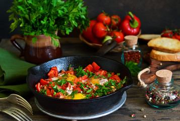 Shakshuka is a traditional breakfast of Israeli cuisine. Eggs fried in tomato sauce with pepper, onions and spices.