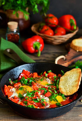 Shakshuka is a traditional breakfast of Israeli cuisine. Eggs fried in tomato sauce with pepper, onions and spices.