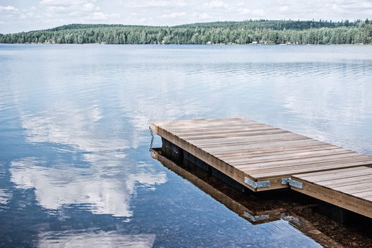 landscape of wooden dock floating in lake at sweden countryside