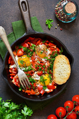 Shakshuka is a traditional breakfast of Israeli cuisine. Eggs fried in tomato sauce with pepper, onions and spices.