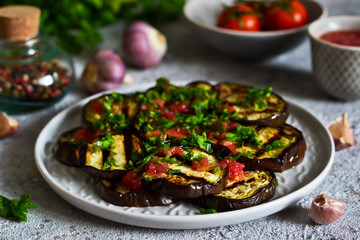 Spicy eggplant with tomato sauce and cilantro. Grilled eggplant.