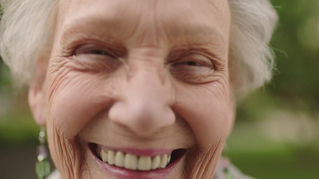 close up portrait of confident elderly woman laughing looking at camera