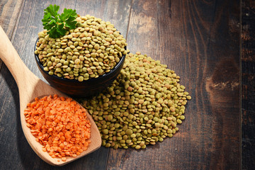 Composition with bowl of lentils on wooden table