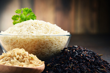 Composition with bowl of rice on wooden table