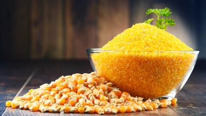 Composition with bowl of corn on wooden table © monticellllo