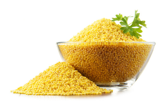 Composition with bowl of millet isolated on white