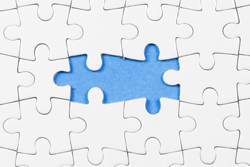 Blue background made from white puzzle pieces and place for your content 