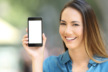 Happy lady showing a blank phone screen mock up