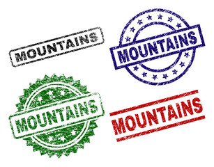 MOUNTAINS seal prints with damaged texture. Black, green,red,blue vector rubber prints of MOUNTAINS caption with retro texture. Rubber seals with circle, rectangle, medallion shapes.