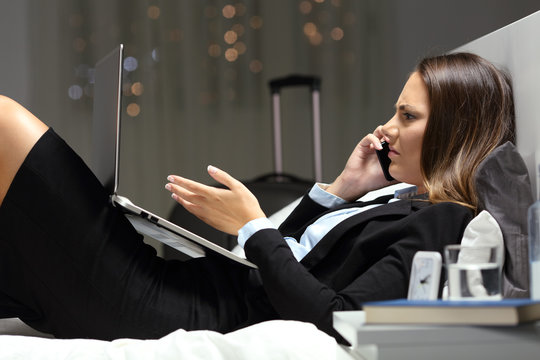 Angry businesswoman complaining on phone in an hotel