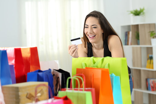 Happy shopper looking at multiple purchases