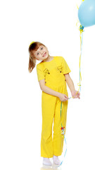 Girl with a short bangs on her head and bright yellow overalls.