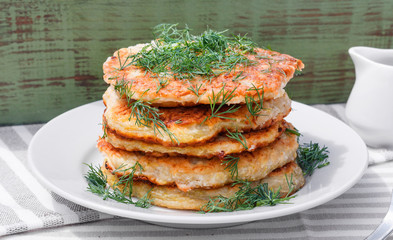 Delicious pancakes from courgettes and fresh vegetables with sour cream and dill