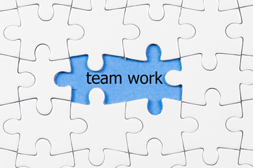 puzzle pieces with teamwork word