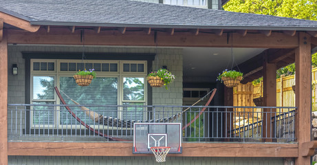 Basketball hoop and hammock on cozy exterior © Jason