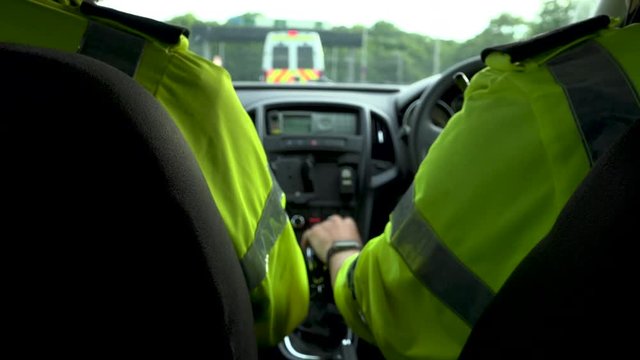 Police officers follow van in suburban roads