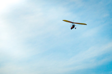 Fototapeta na wymiar Glider high in the sky. Glider on a blue sky background.