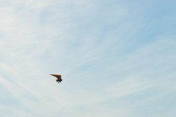 Glider high in the sky. Glider on a blue sky background.