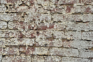 Peeling paint on brick wall on side of vintage building