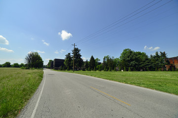 Road leading to large rickhouse on the bourbon trail