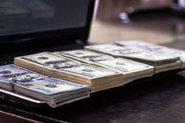 Macro shot of 100 dollar. Dollars Close Up Concept. American Dollars Cash Money. Lots of money on the laptop. Business, computers