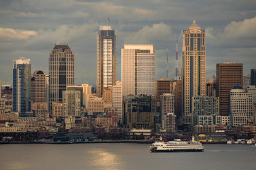 Fototapeta premium Seattle Skyline After A Rain Squall. Dramatic clouds surround the city of Seattle and the vibrant waterfront with modern skyscrapers looming large in the background.