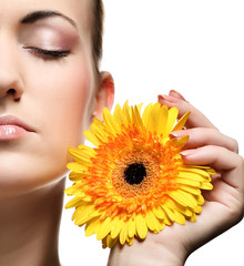 Beautiful young woman with gerber flower
