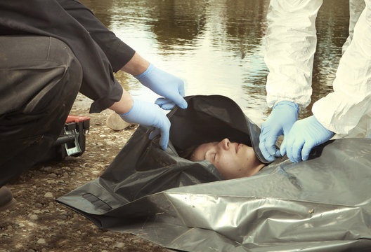 Woman Found Drowned On River Bank In City Placed In Body Bag For Transportration