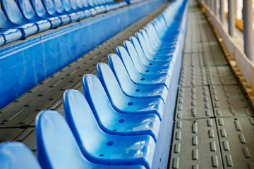 Empty plastic chairs in the stands of the stadium