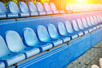 Fototapeta premium Empty plastic chairs in the stands of the stadium