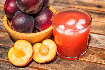 Fresh plum smoothie with plums close