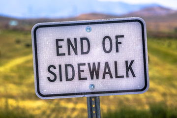 End of sidewalk sign canted and tilted