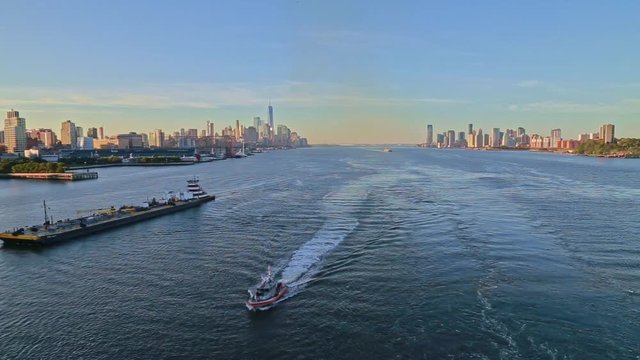 Aerial video of boat in Hudson River with New York City skyline in the background