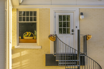 Front door with spiral stairs of yellow house