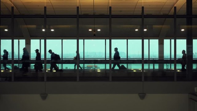 Silhouette of people who are embarking on a flight in Rome airport.