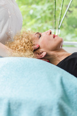 Woman having head massage at salon