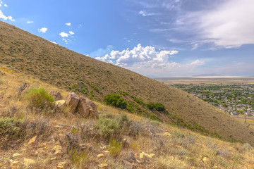 Obraz premium Hills with dead foliage and view of homes