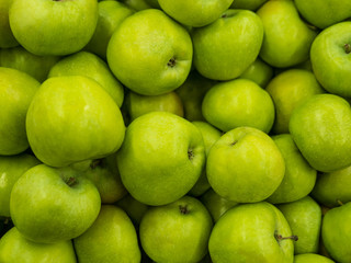 Green apples. Fitness diet detox concept. Green fresh apples harvests Close up. A backdrop of Green fresh apples. Street vegetable market. Group of Green fresh tasty apples pattern texture background