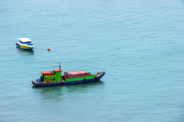 Traditional fishing boat and speed boat floating in the sea after send the tourists.